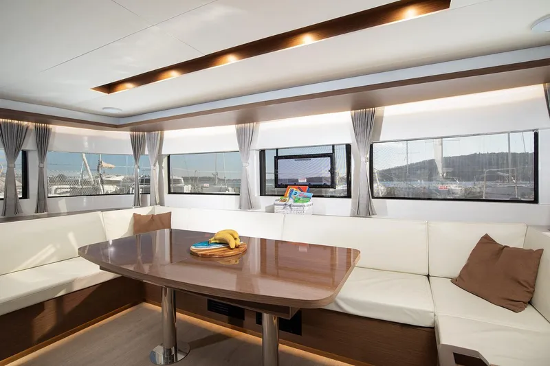 Aliana Yacht Photos Pics Luxurious interior of 2022 Lagoon 50 yacht with elegant seating and dining area.