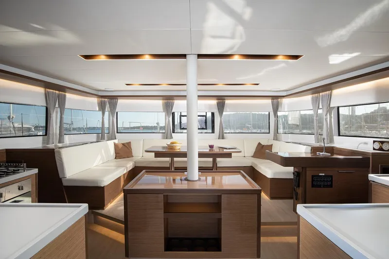 Aliana Yacht Photos Pics Luxurious interior of 2022 Lagoon 50 catamaran with modern furnishings and panoramic windows.