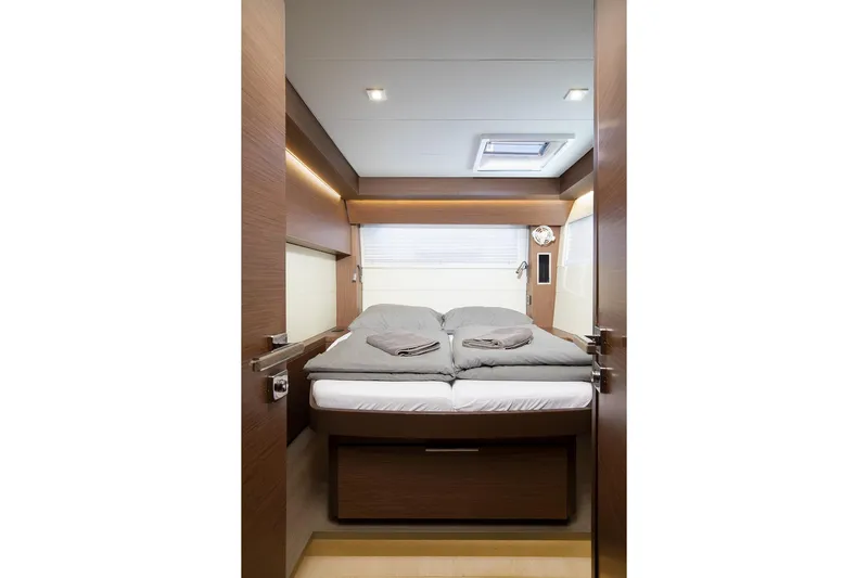Aliana Yacht Photos Pics Luxurious cabin interior of 2022 Lagoon 50 yacht with cozy bedding and modern design.
