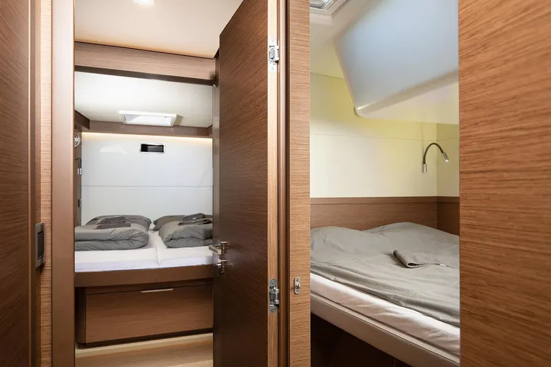 Aliana Yacht Photos Pics Interior of 2022 Lagoon 50 yacht featuring cozy twin cabins with modern wood finish.