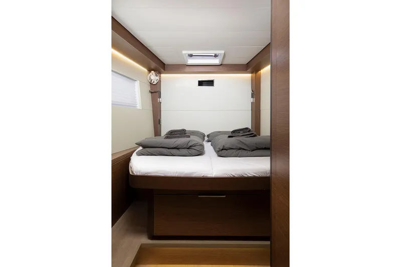 Aliana Yacht Photos Pics Luxurious cabin interior of 2022 Lagoon 50 yacht with cozy bedding.
