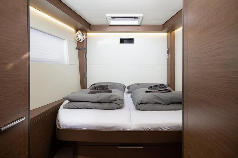 Aliana Yacht Photos Pics Luxurious cabin interior of 2022 Lagoon 50 yacht with cozy bedding.