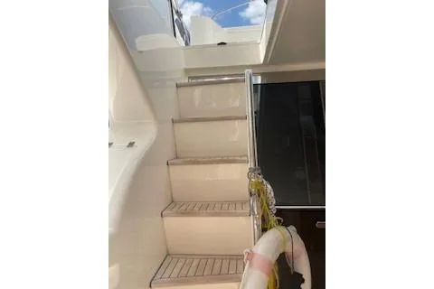  Yacht Photos Pics Staircase on 2009 Ferretti Yachts 681, leading to upper deck, with clear sky view.