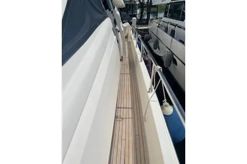  Yacht Photos Pics 2009 Ferretti Yachts 681 side deck with wooden flooring and docked boats.