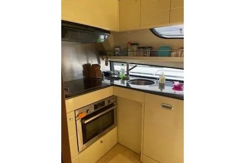  Yacht Photos Pics Compact kitchen in 2009 Ferretti Yachts 681, featuring modern appliances and sleek design.