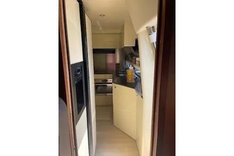  Yacht Photos Pics Compact kitchen area inside a 2009 Ferretti Yachts 681, featuring modern appliances and storage.