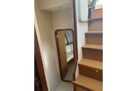  Yacht Photos Pics Interior view of 2009 Ferretti Yachts 681, featuring wooden stairs and a mirror.