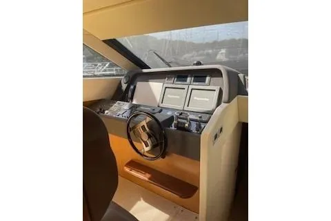  Yacht Photos Pics 2009 Ferretti Yachts 681 helm with modern navigation equipment and steering wheel.