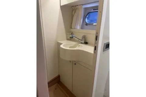  Yacht Photos Pics 2009 Ferretti Yachts 681 bathroom with modern sink and porthole window.
