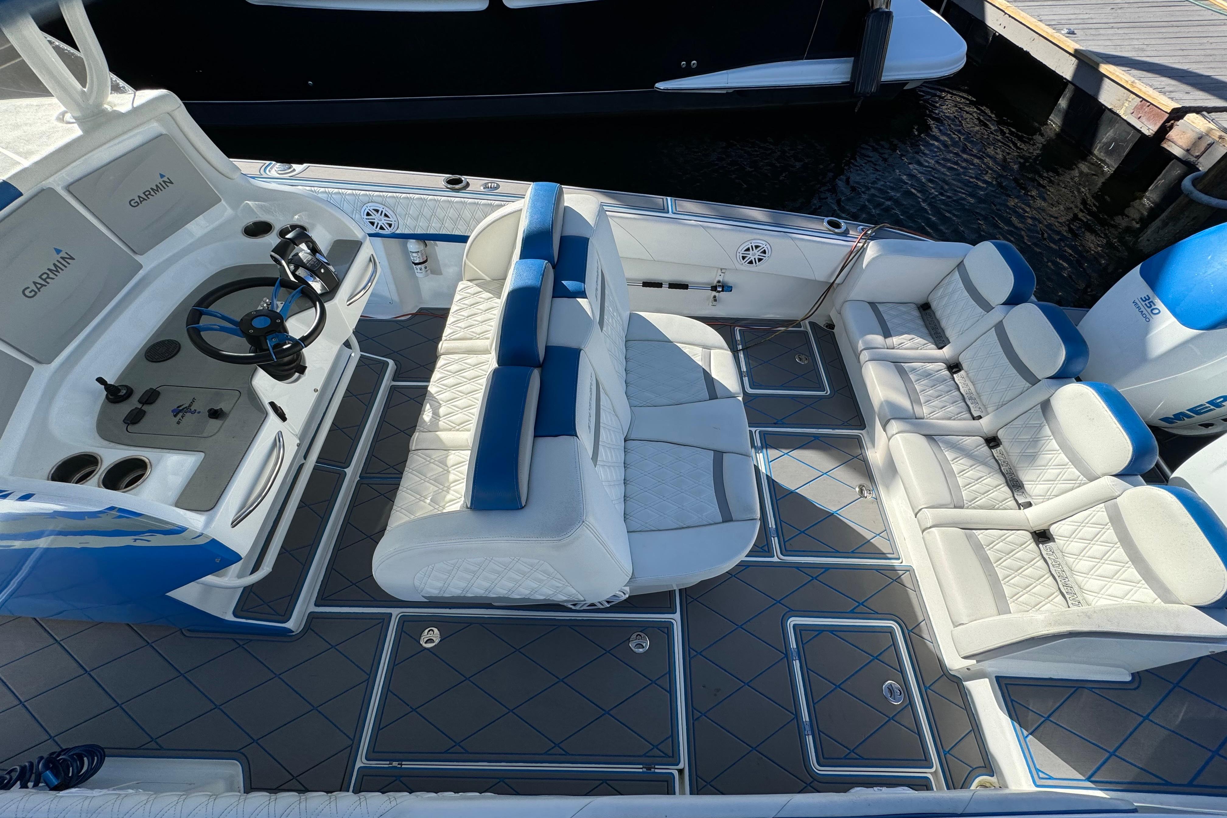 2016 Statement 350 Open boat interior with white seating and Garmin-equipped helm.