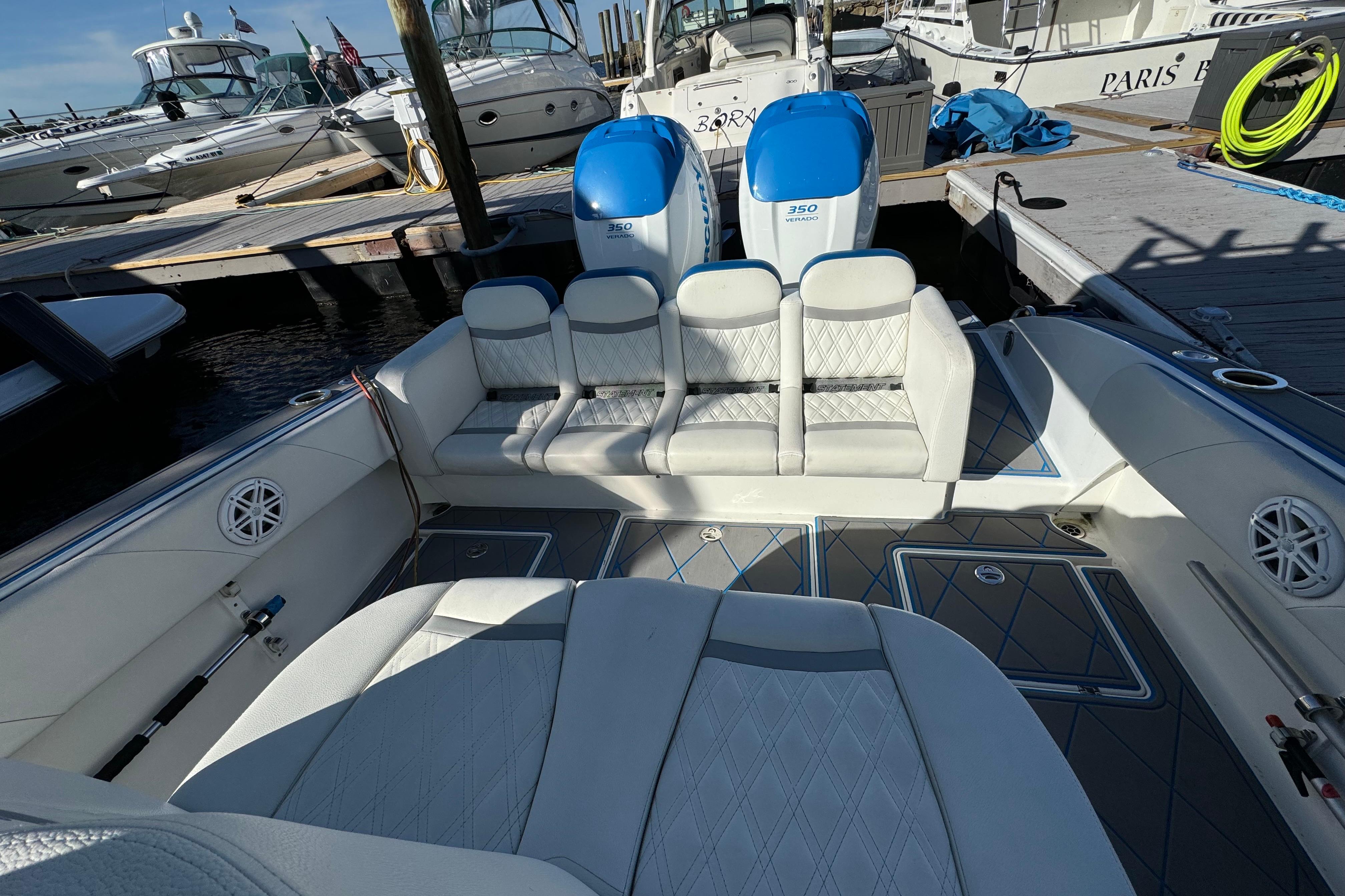Luxury 2016 Statement 350 Open boat interior with plush seating at marina.