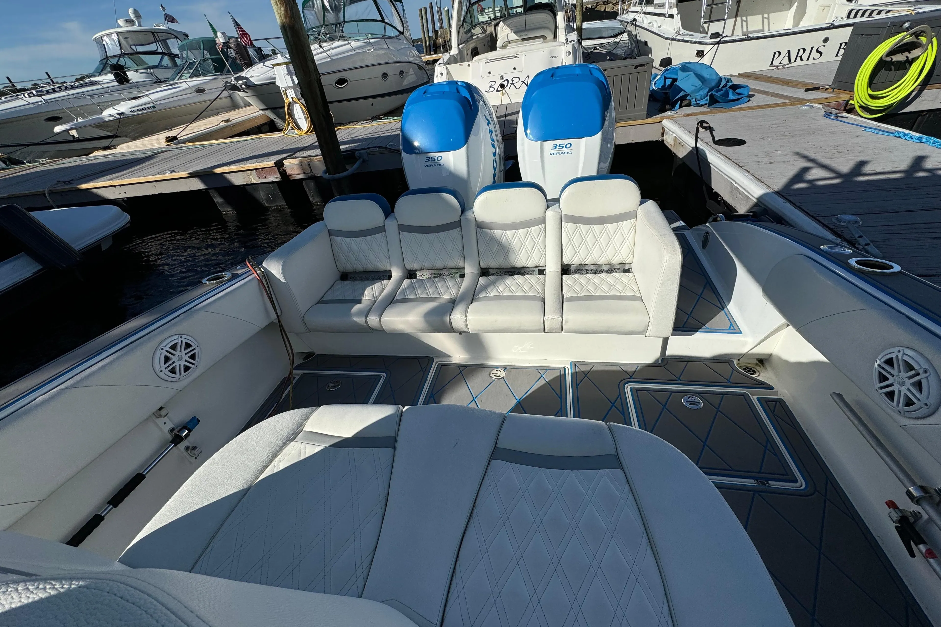 Luxury 2016 Statement 350 Open boat interior with plush seating at marina.