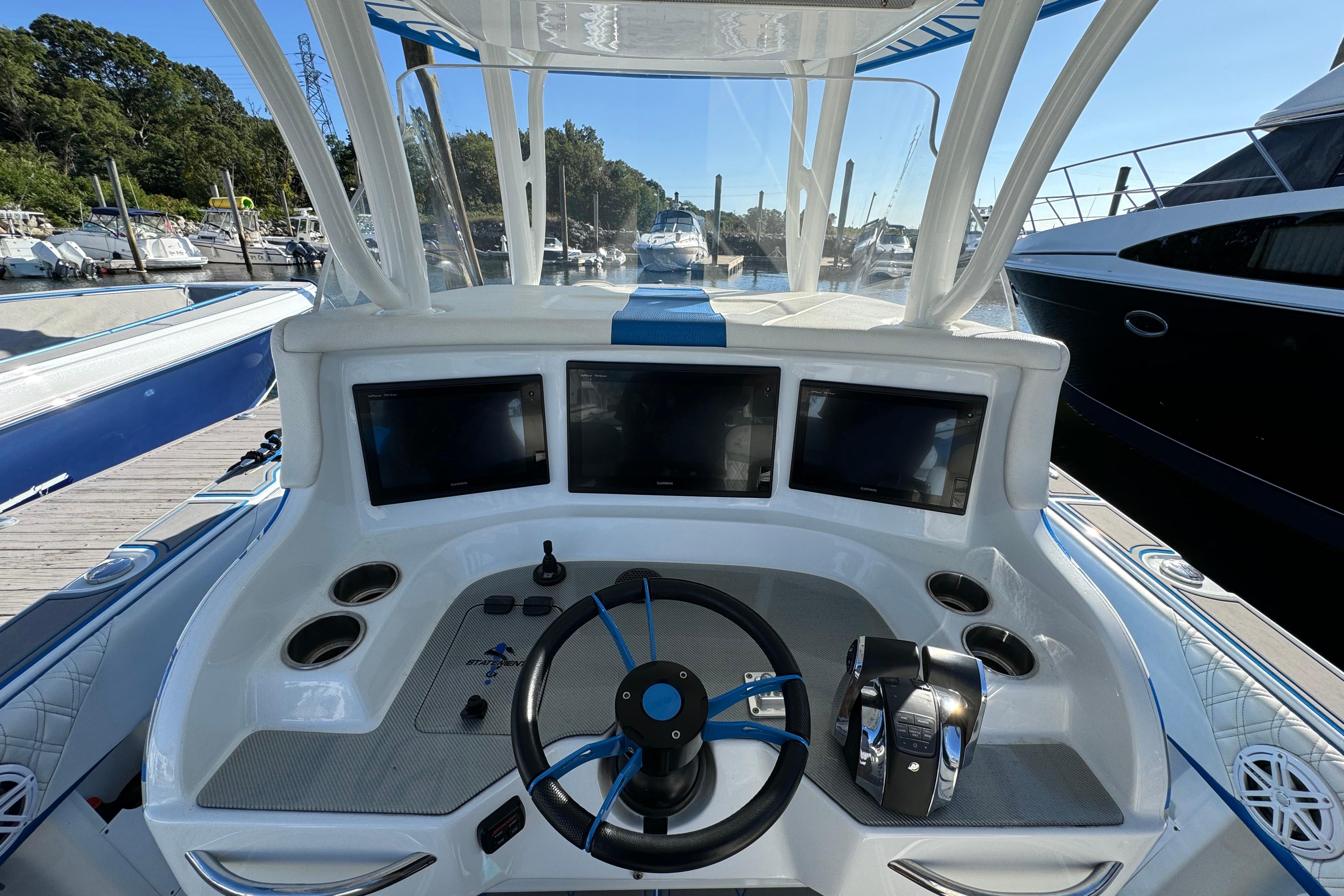 Cockpit of 2016 Statement 350 Open boat with modern navigation displays and controls.