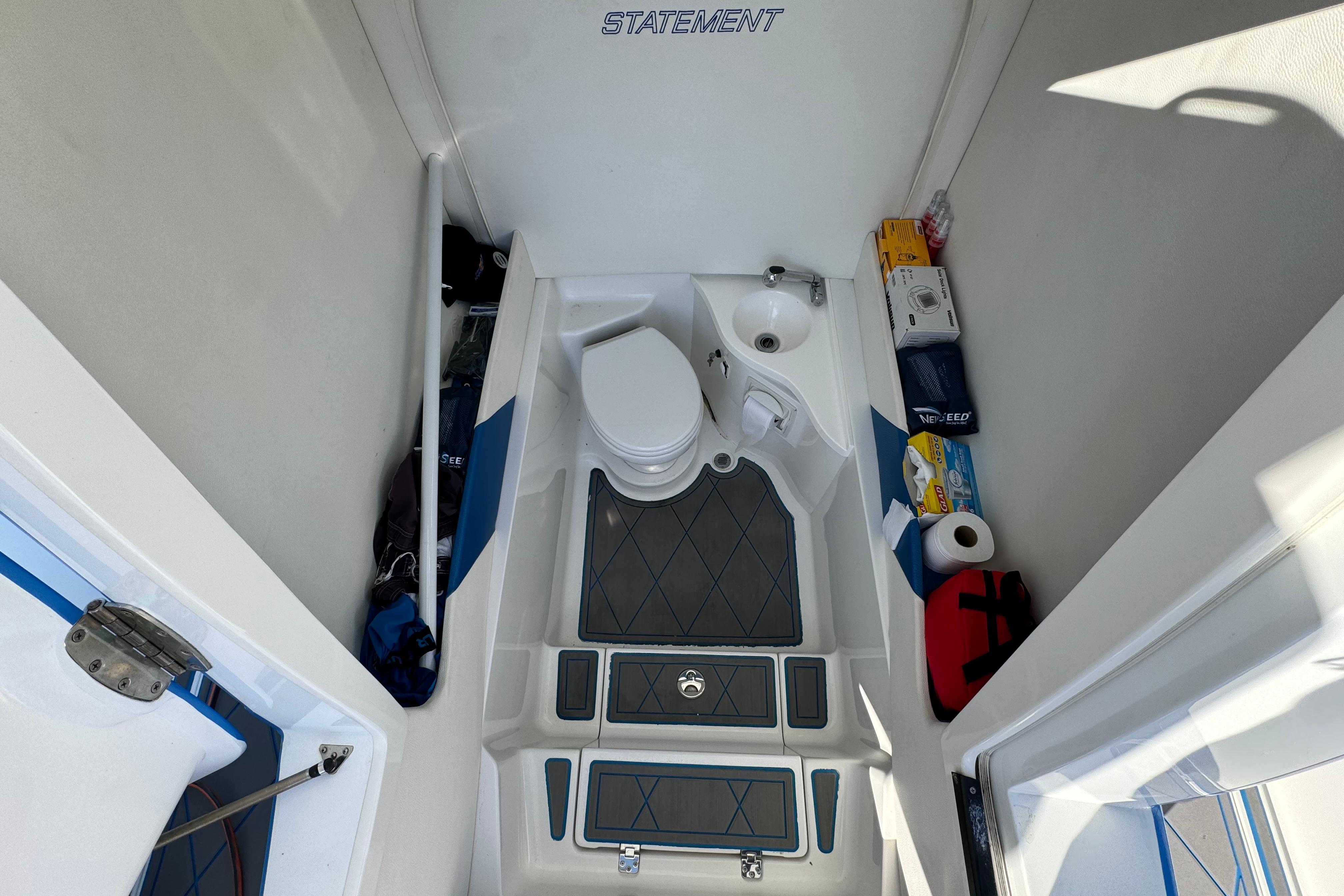 Interior of 2016 Statement 350 Open boat with toilet and storage compartments.