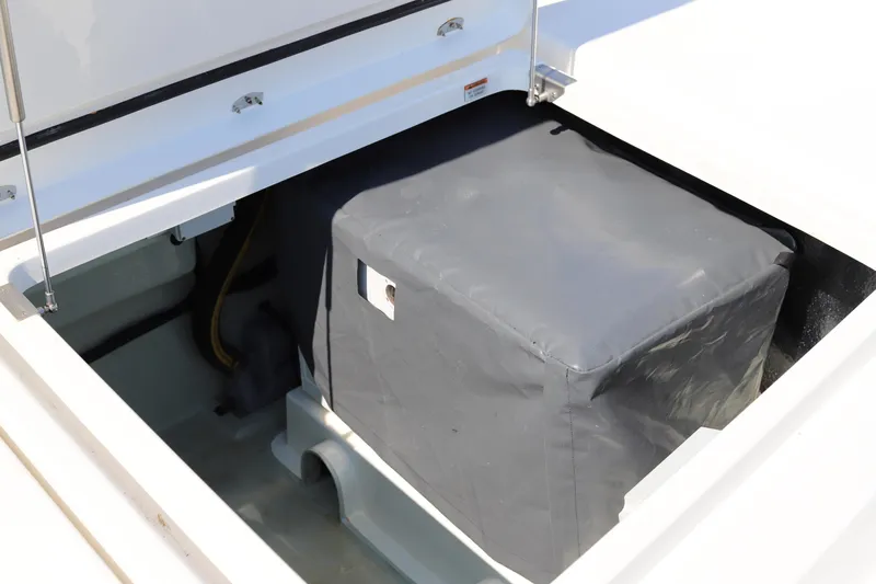 Why Knot Yacht Photos Pics Open compartment on 2020 Robertson Leopard boat, showing covered equipment inside.