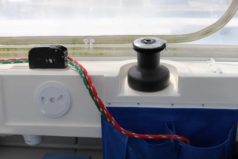 Why Knot Yacht Photos Pics Sailing equipment on a 2020 Robertson Leopard boat, featuring a winch and colorful rope.