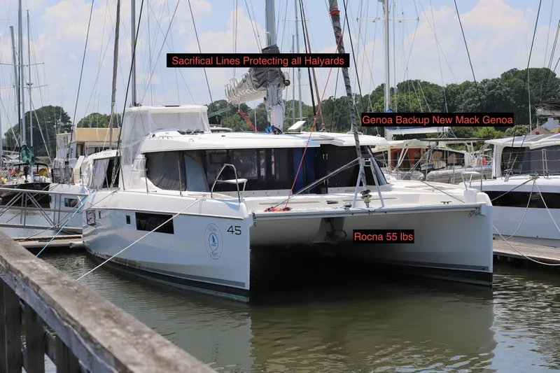 Why Knot Yacht Photos Pics Robertson Leopard 2020 catamaran docked, featuring sacrificial lines and Rocna 55 lbs anchor.