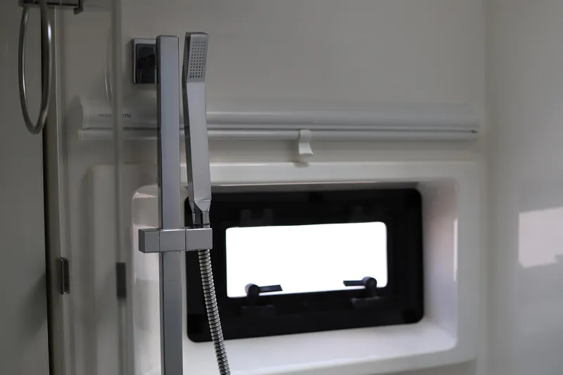 Why Knot Yacht Photos Pics Modern shower area in 2020 Robertson Leopard yacht, featuring sleek fixtures and window.