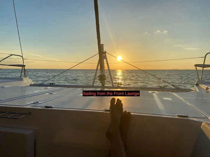 Why Knot Yacht Photos Pics Sunset view from Robertson Leopard 2020 yacht's front lounge, sailing on the ocean.