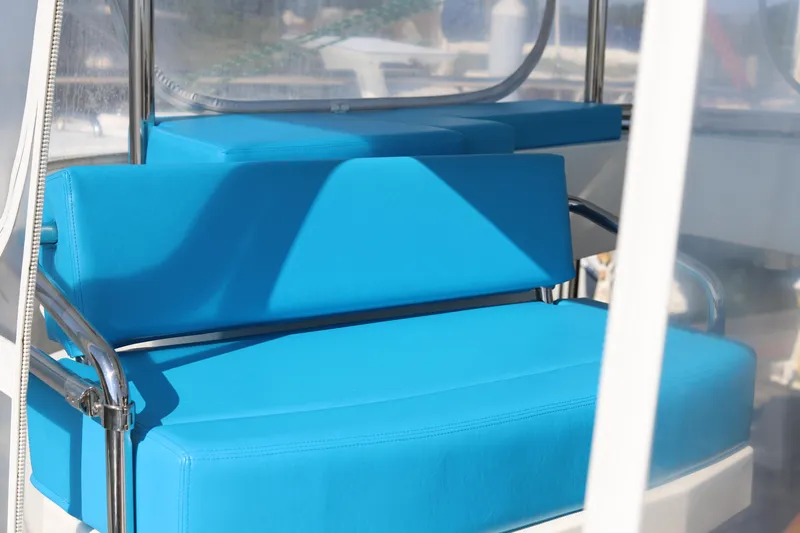 Why Knot Yacht Photos Pics Blue seating on a 2020 Robertson Leopard boat, featuring sleek metal frames.