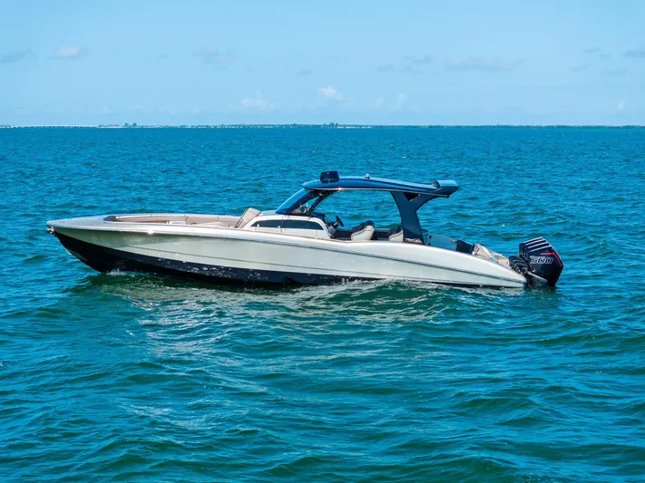  Yacht Photos Pics 2021 MTI V42 boat on open water under clear blue sky.