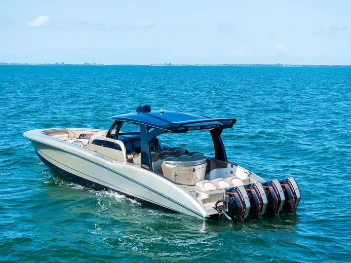  Yacht Photos Pics MTI V42 2021 boat cruising on open water with four powerful outboard engines.