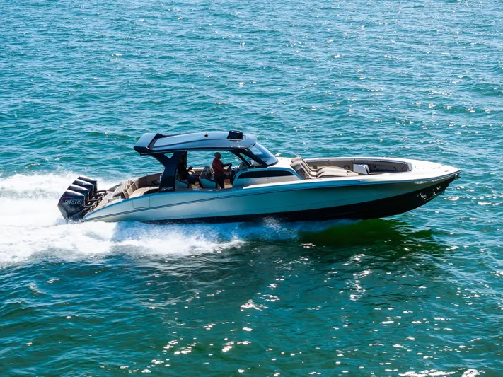  Yacht Photos Pics 2021 MTI V42 boat cruising on open water, showcasing sleek design and powerful engines.
