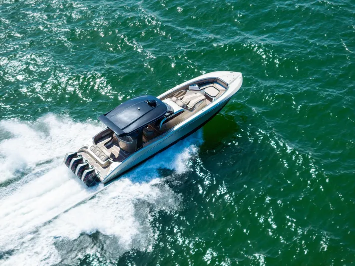  Yacht Photos Pics MTI V42 2021 speedboat cruising on open water, aerial view.