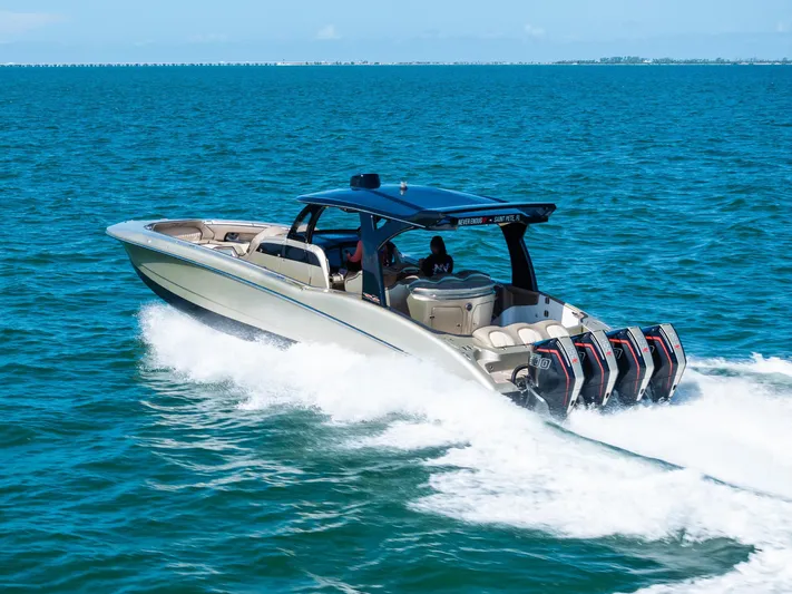  Yacht Photos Pics 2021 MTI V42 boat cruising on blue ocean waters with powerful engines.