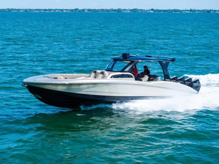  Yacht Photos Pics 2021 MTI V42 speedboat cruising on open water, showcasing sleek design and powerful engines.