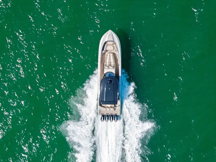  Yacht Photos Pics Aerial view of 2021 MTI V42 boat cruising on green water.