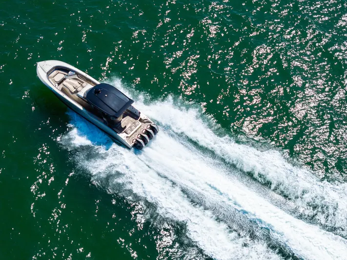  Yacht Photos Pics Aerial view of 2021 MTI V42 speedboat cruising on open water.