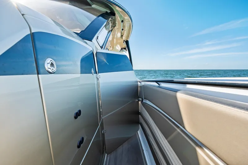  Yacht Photos Pics 2021 MTI V42 boat side view with ocean backdrop and clear blue sky.