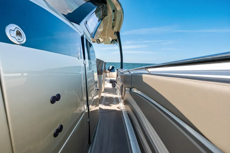  Yacht Photos Pics Luxury MTI V42 boat deck with sleek design, open sea view, and clear blue sky.