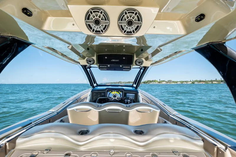  Yacht Photos Pics Luxury MTI V42 boat interior with ocean view, featuring modern seating and audio system, 2021 model.