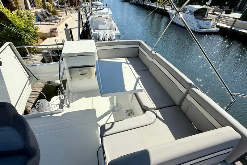 Yacht Photos Pics Flybridge view of 2024 Jeanneau NC 1295 Fly yacht with seating and table.