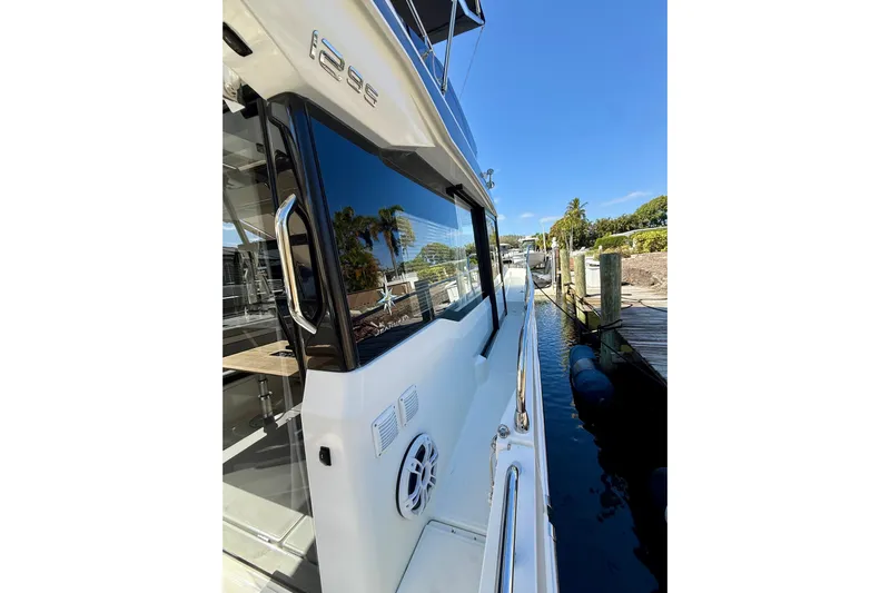  Yacht Photos Pics 2024 Jeanneau NC 1295 Fly yacht docked, showcasing sleek design and modern features.