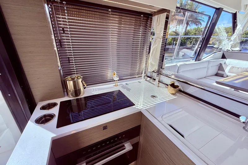  Yacht Photos Pics Modern kitchen interior of 2024 Jeanneau NC 1295 Fly yacht with sleek design and appliances.