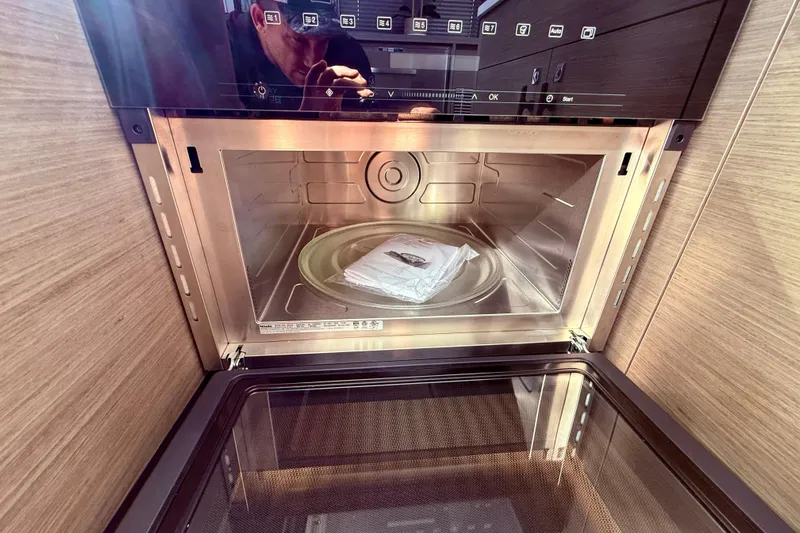  Yacht Photos Pics 2024 Jeanneau NC 1295 Fly kitchen microwave interior with digital controls.