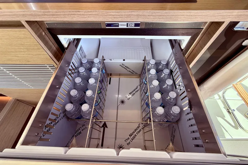  Yacht Photos Pics Open drawer fridge with water bottles on Jeanneau NC 1295 Fly, 2024 model.