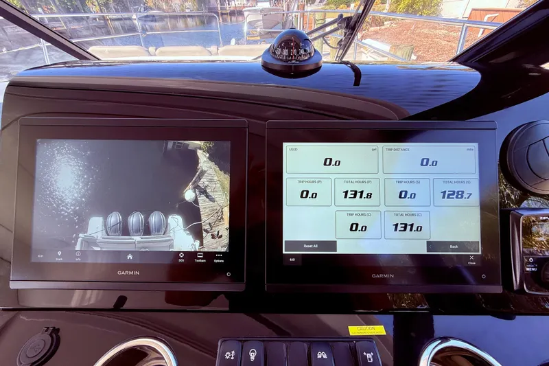  Yacht Photos Pics 2024 Jeanneau NC 1295 Fly cockpit with Garmin displays showing navigation and engine data.