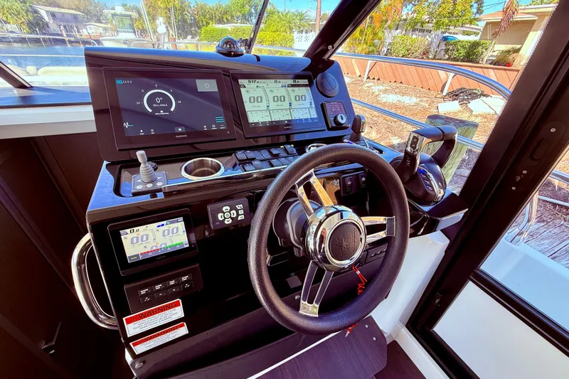  Yacht Photos Pics Helm of 2024 Jeanneau NC 1295 Fly with advanced navigation displays and controls.