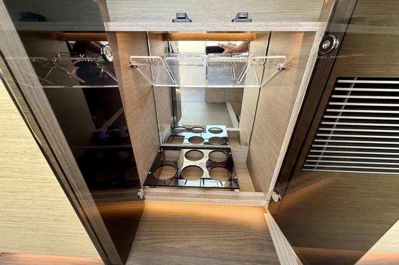  Yacht Photos Pics 2024 Jeanneau NC 1295 Fly yacht interior cabinet with glass holders and storage.