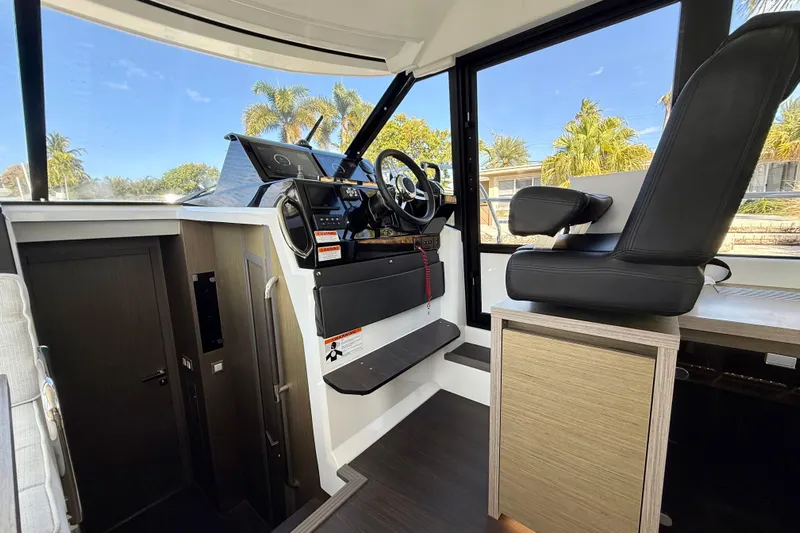  Yacht Photos Pics 2024 Jeanneau NC 1295 Fly cockpit with modern controls and comfortable seating.