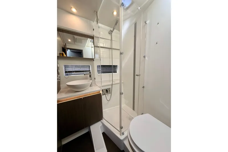  Yacht Photos Pics Modern bathroom in 2024 Jeanneau NC 1295 Fly yacht with sleek fixtures and glass shower.