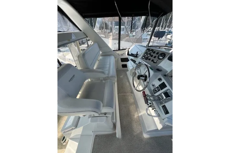 Yacht Photos Pics 1999 Carver 404 Cockpit Motor Yacht helm with dual seating and control panel.