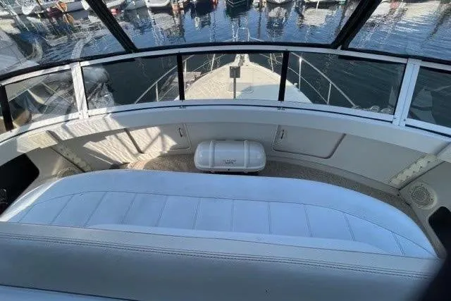  Yacht Photos Pics 1999 Carver 404 Cockpit Motor Yacht interior with white seating and marina view.