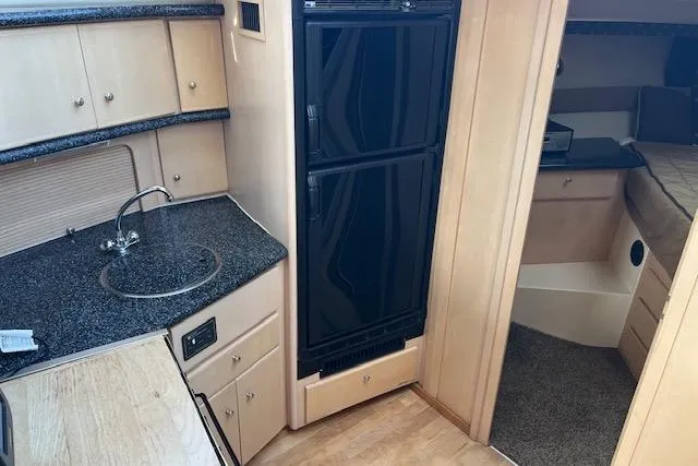  Yacht Photos Pics Interior of 1999 Carver 404 Cockpit Motor Yacht with kitchenette and sleeping area.