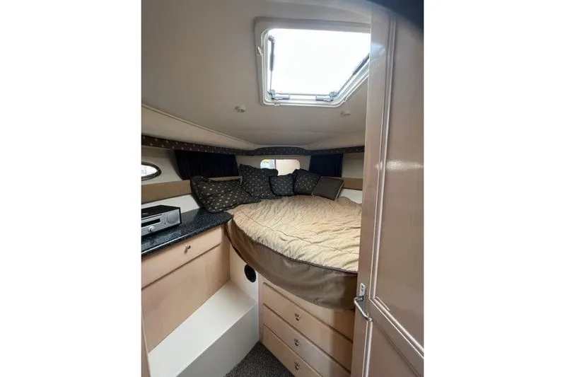  Yacht Photos Pics 1999 Carver 404 Cockpit Motor Yacht interior with cozy bed and storage drawers.