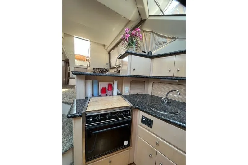  Yacht Photos Pics Interior of 1999 Carver 404 Cockpit Motor Yacht with kitchen and floral decor.